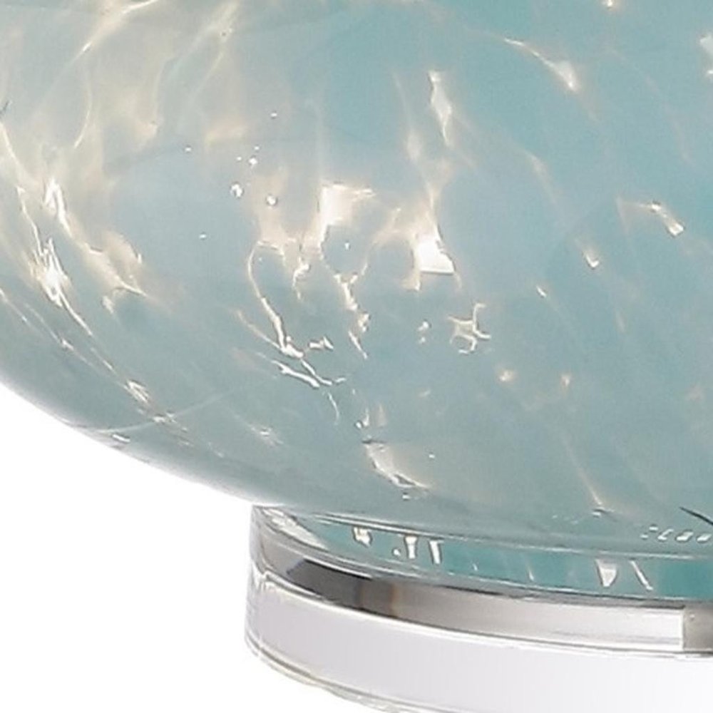 Close-up of 29" Light Blue And Clear Teardrop Glass Table Lamp With Drum Shade showing blue glass detail.