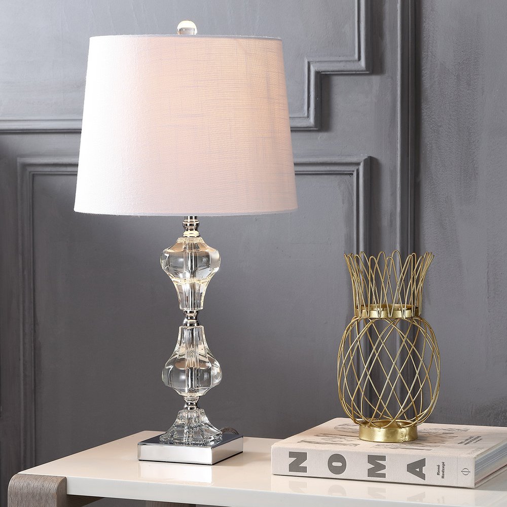 26" Silver Urn Table Lamp With Empire Shade displayed on a tabletop in a furnished interior against a light gray wall.