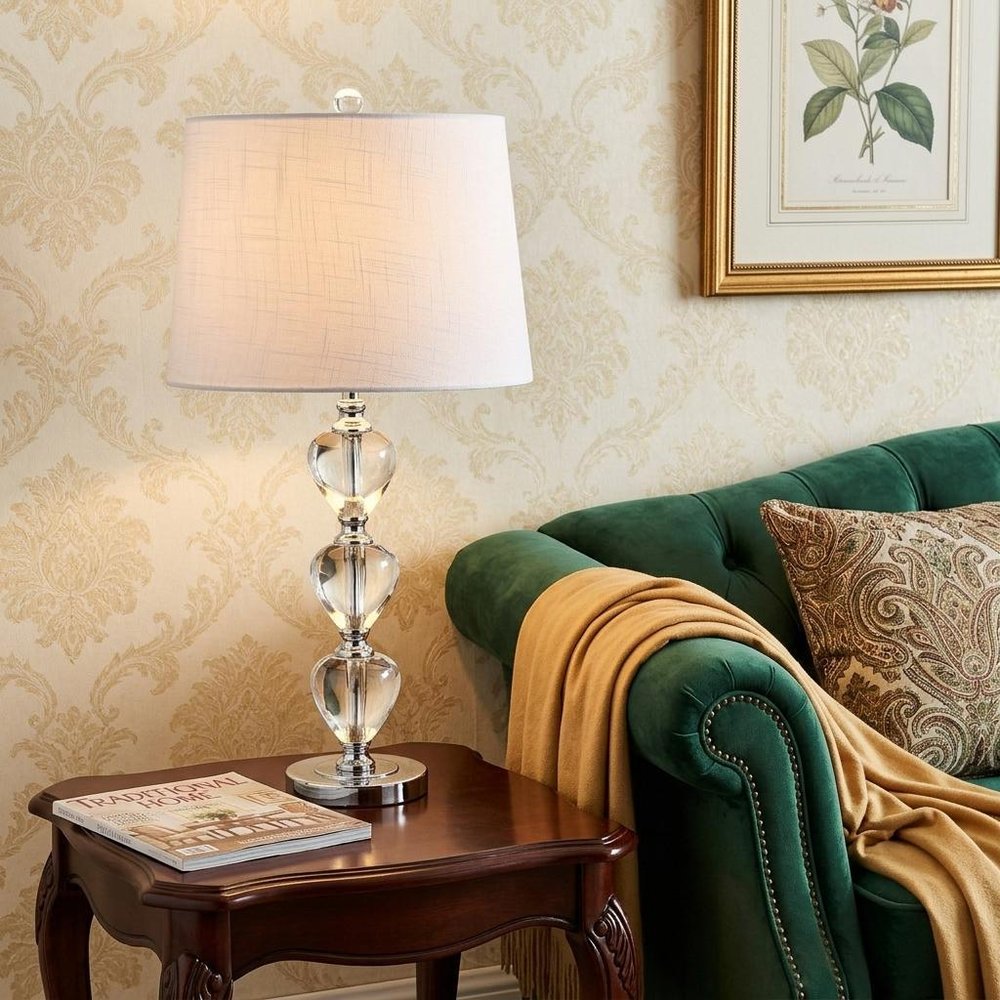 27" Silver Globe Table Lamp With Drum Shade displayed on a tabletop in a furnished interior against a cream wall.