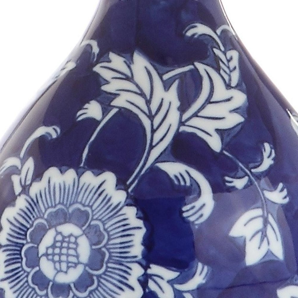 Cropped view of 27" Blue Gold And White Novelty Table Lamp With Drum Shade focusing on the blue surface.