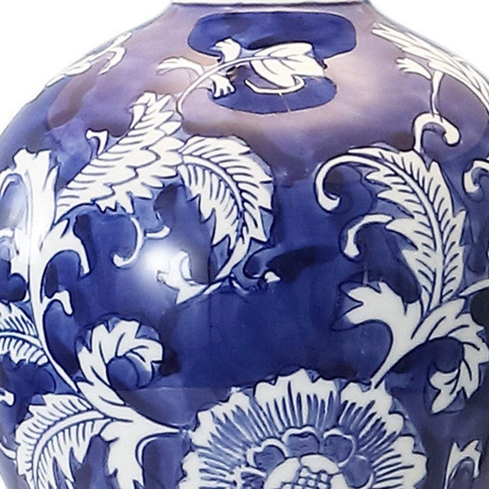 Cropped view of 24" Blue Gold And White Urn Bedside Lamp With Empire Shade focusing on the white surface.