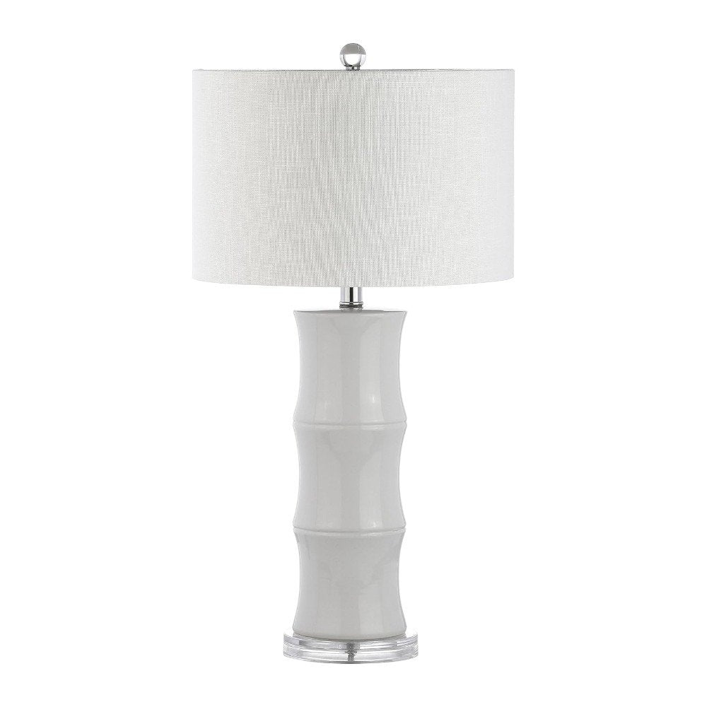 27" Clear Table Lamp With Drum Shade. Table lamp isolated on a plain white background, showing its clear color.
