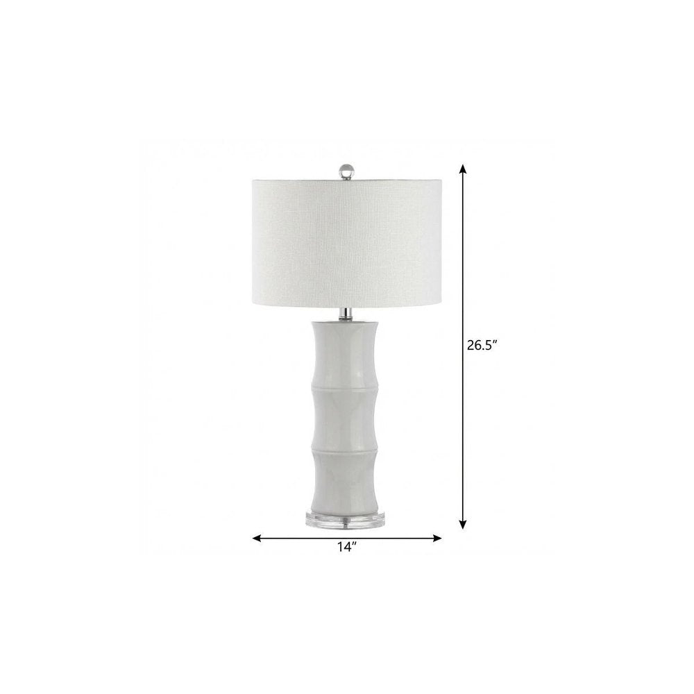 27" Clear Table Lamp With Drum Shade. Table lamp isolated on a plain white background, showing its clear color.