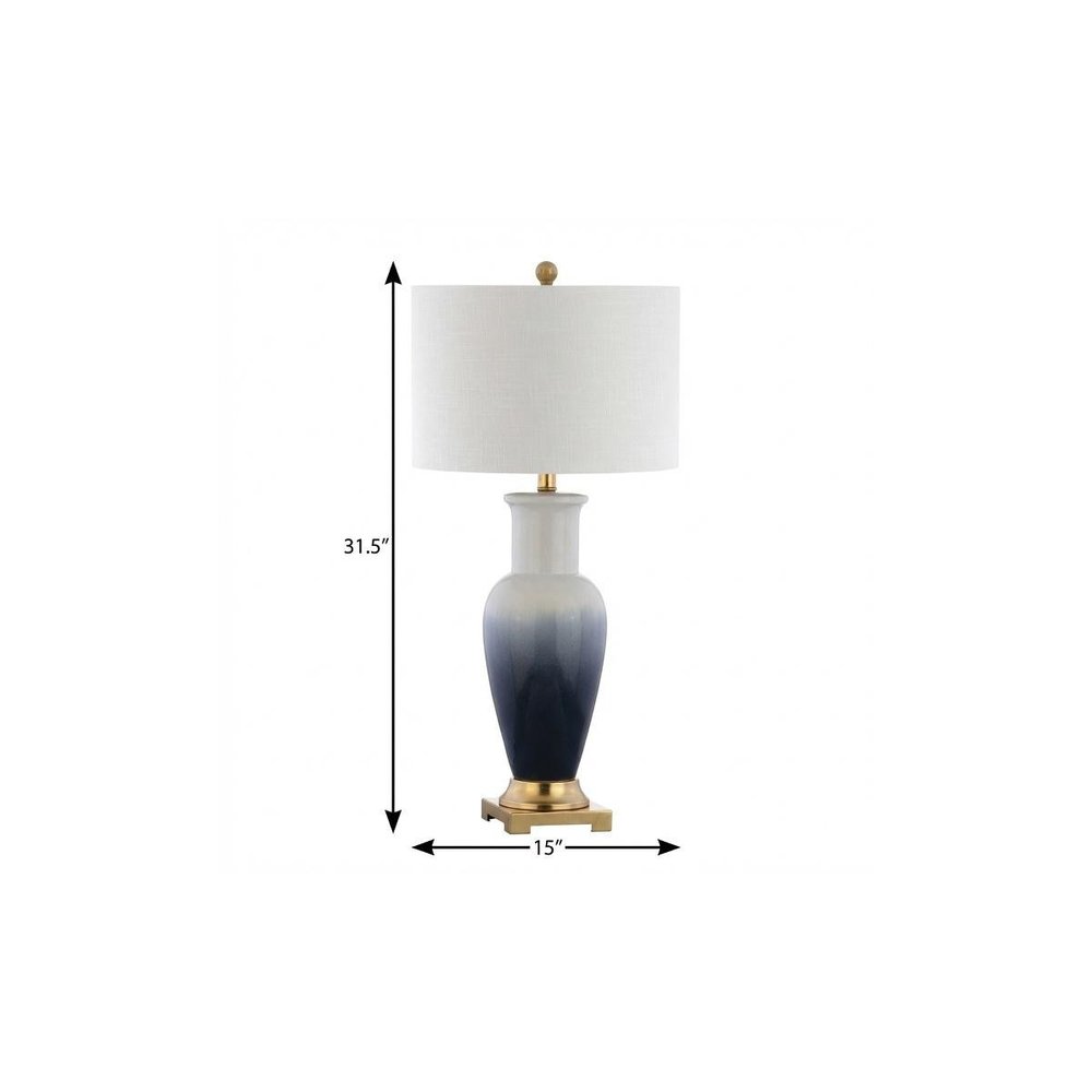 32" Gold Novelty Table Lamp With Drum Shade. Table lamp isolated on a plain white background.