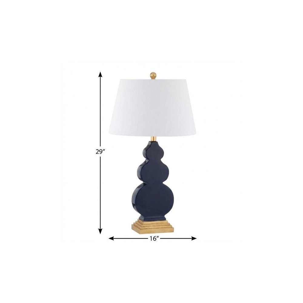 29" Gold Novelty Table Lamp With Drum Shade. Table lamp isolated on a plain white background.