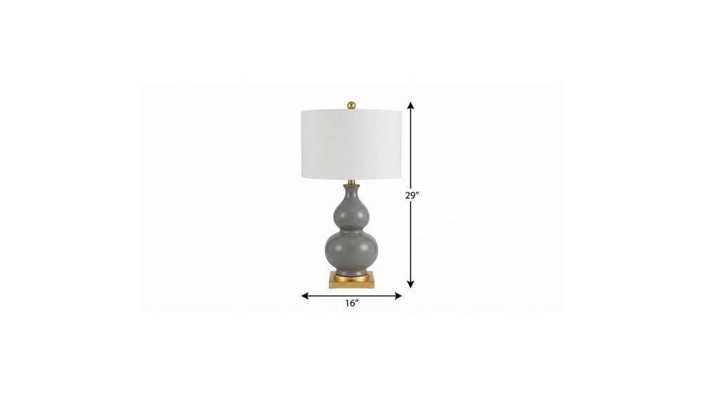 29" Gold Novelty Table Lamp With Drum Shade. Table lamp isolated on a plain white background.