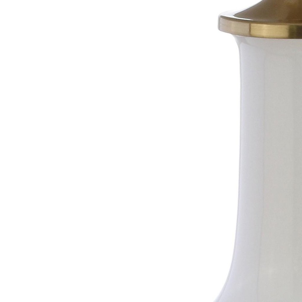 25" Gold Novelty Table Lamp With Drum Shade. Table lamp isolated on a plain white background.