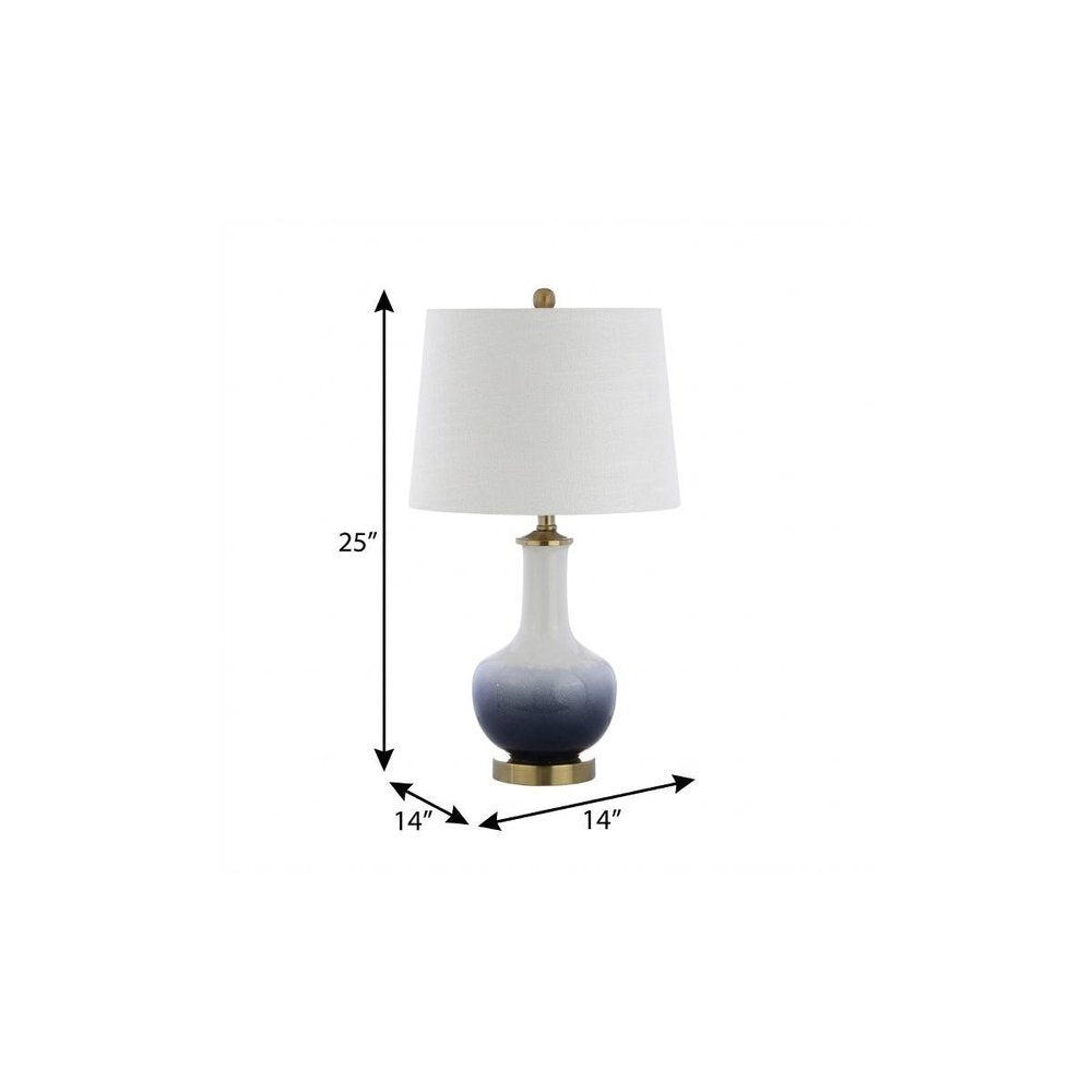 25" Gold Novelty Table Lamp With Drum Shade. Table lamp isolated on a plain white background.