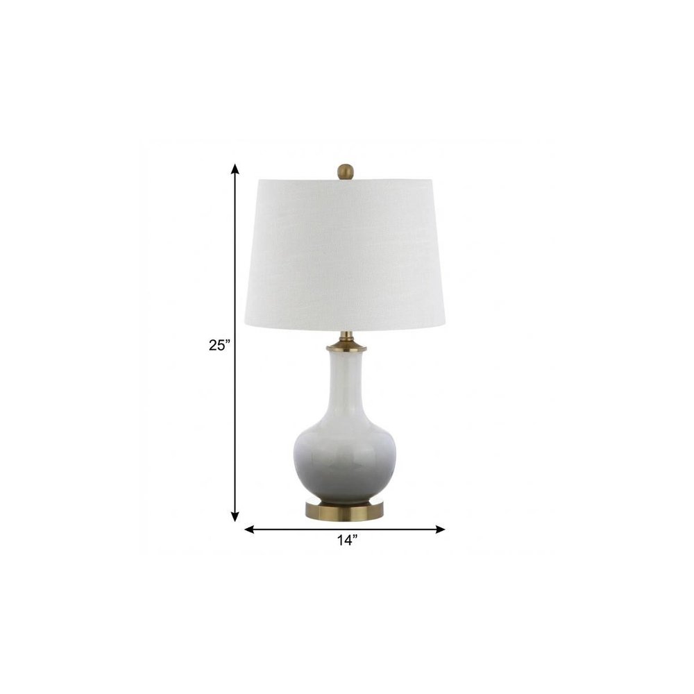 25" Gold Novelty Table Lamp With Drum Shade. Table lamp isolated on a plain white background.