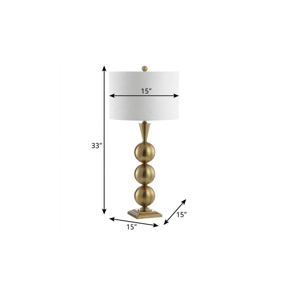 33" Gold Novelty Table Lamp With Drum Shade. Table lamp isolated on a plain white background, in a gold finish.