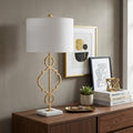 31" White Novelty Table Lamp With Drum Shade displayed on a dark wood tabletop in a furnished interior against a tan wall.