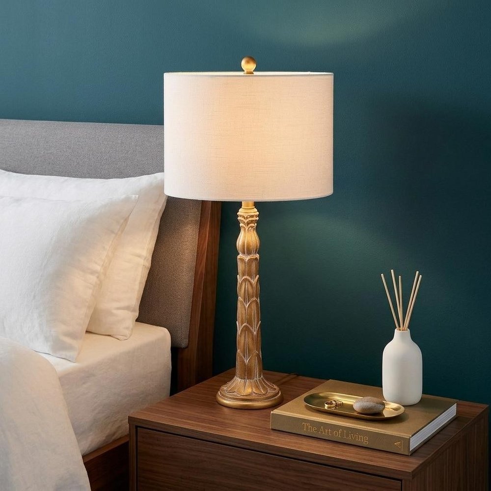 29" Antiqued Gold Table Lamp With Drum Shade shown outdoors on an outdoor setting.