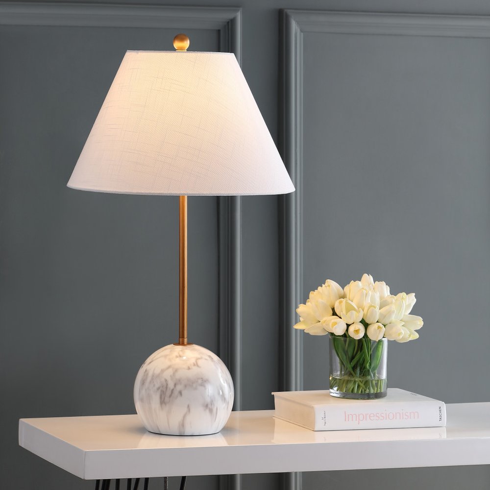 29" White Globe Table Lamp With Globe Shade displayed on a tabletop in a furnished interior against a dark wall.