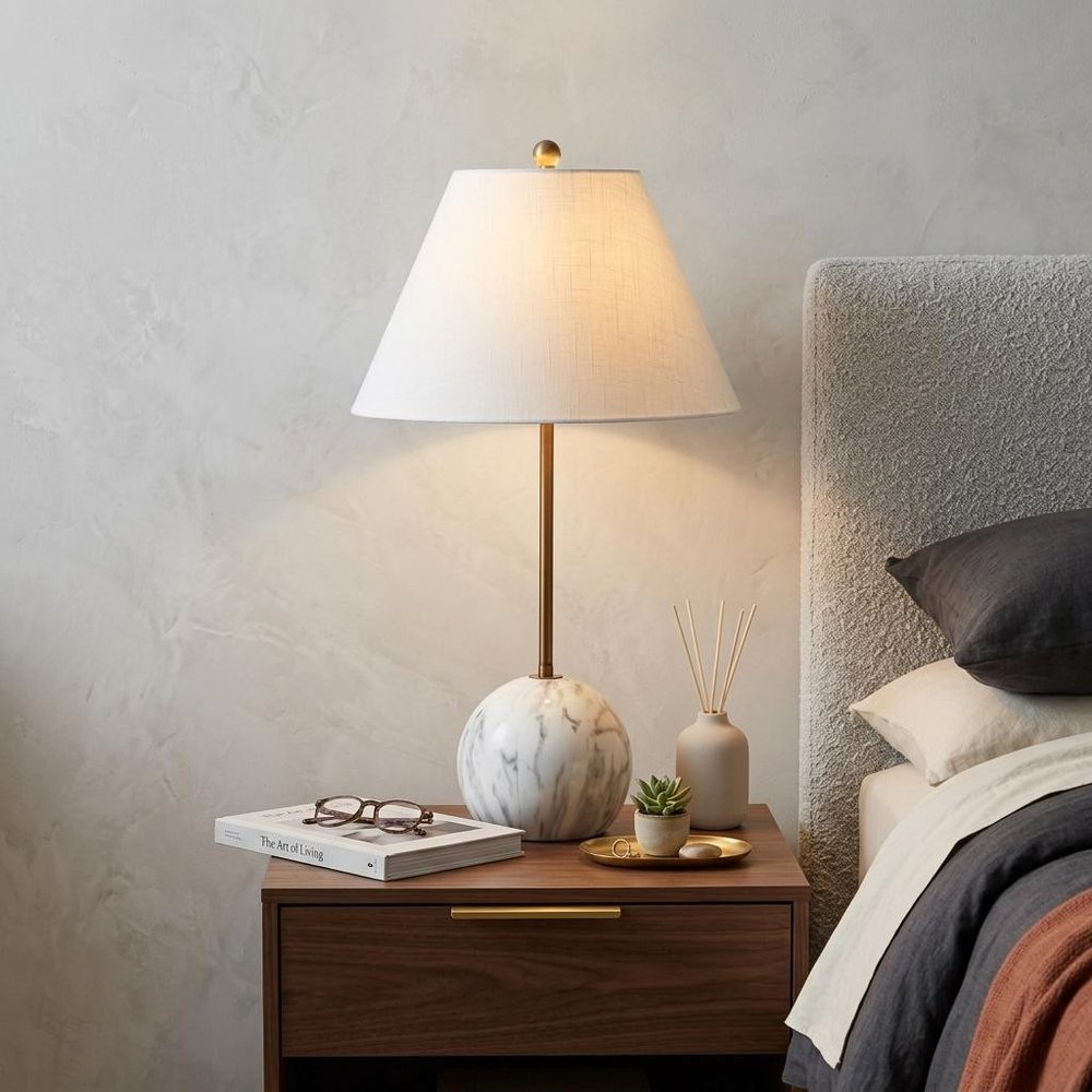 29" White Globe Table Lamp With Globe Shade displayed on a dark wood tabletop in a furnished interior against a light gray wall.