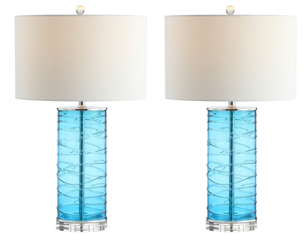 Two turquoise glass cylinder table lamps with white drum shades and clear bases, set against a white background.