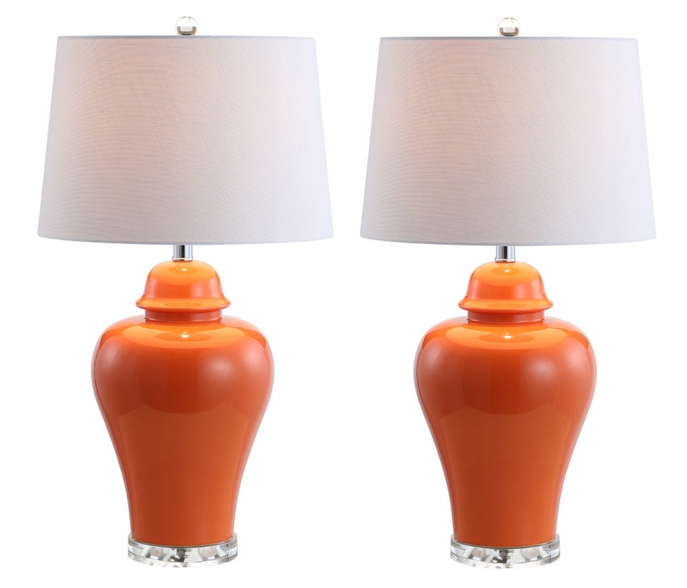 Pair of orange ceramic ginger jar table lamps with white globe shades and clear bases on a white background.
