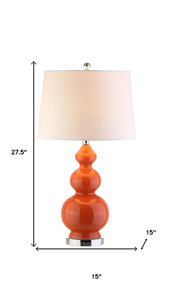 28" Orange And Silver Novelty Table Lamp With Drum Shade. Table lamp isolated on a plain white background.
