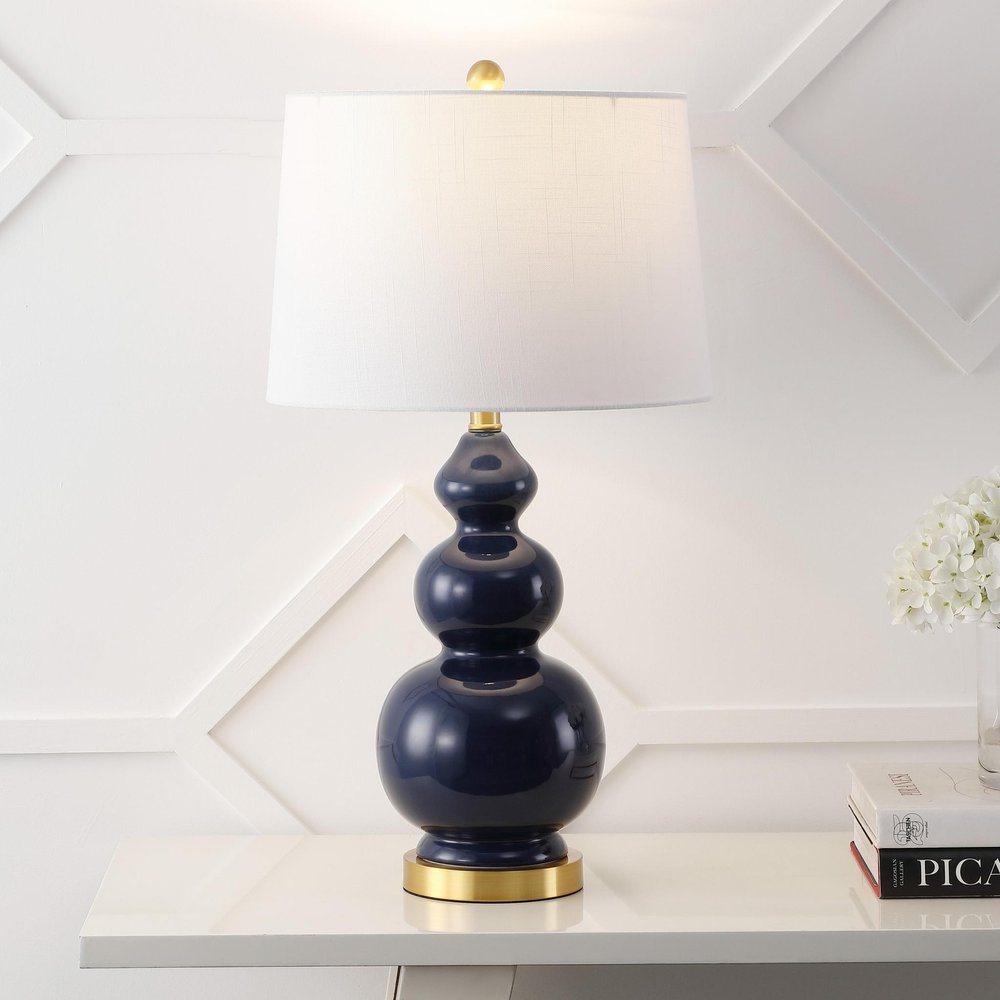 Cropped view of 28" Navy Blue And Gold Novelty Table Lamp With Empire Shade focusing on the surface surface.