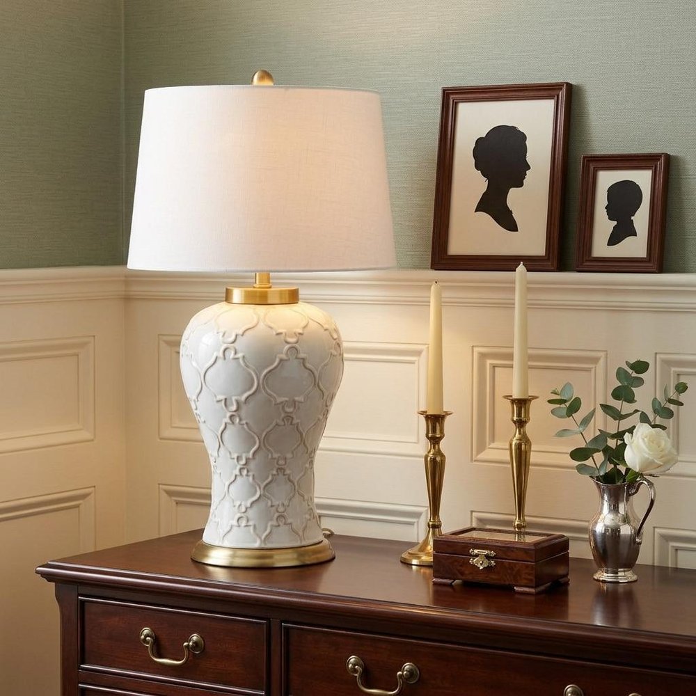 29" Gold Novelty Table Lamp With Drum Shade displayed on a tabletop in a furnished interior against a cream wall.