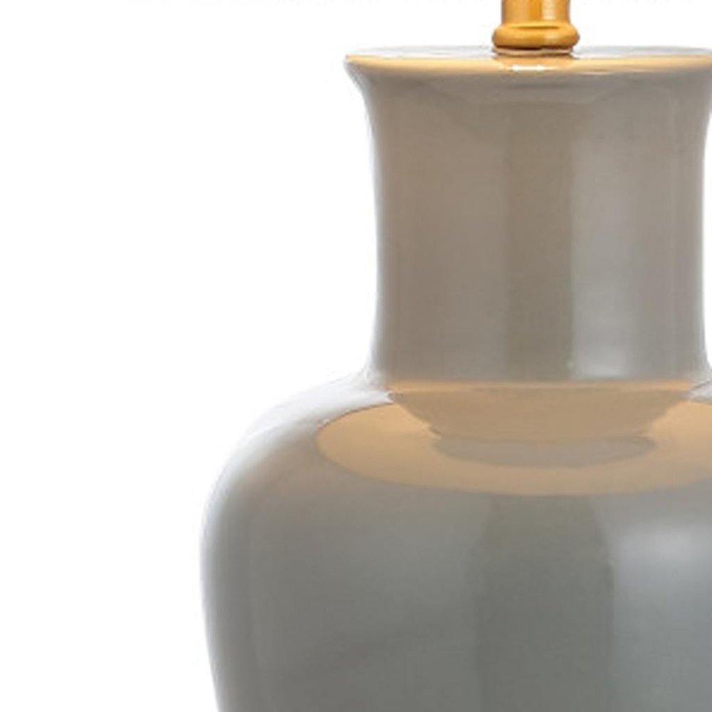 29" Gray And Gold Urn Bedside Lamp With Drum Shade. Lamp isolated on a plain white background, finished in gold.