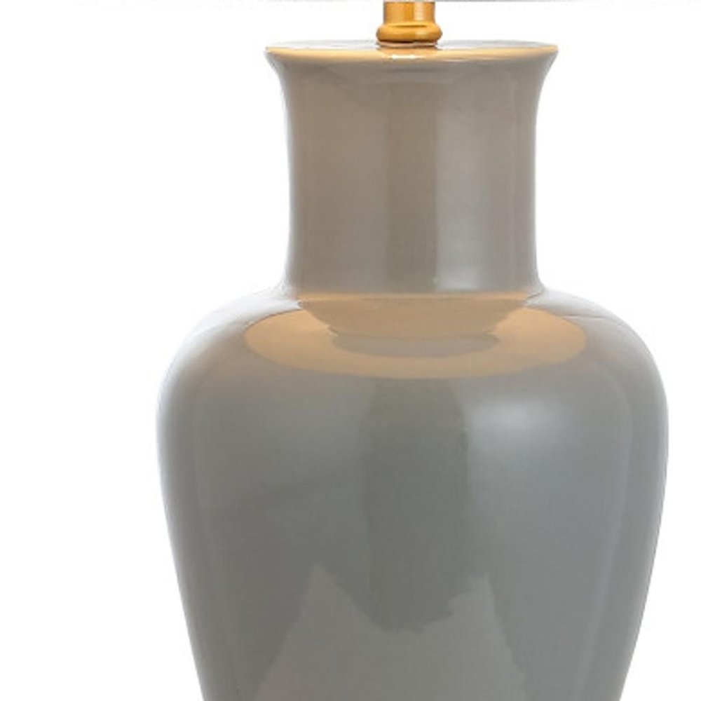 29" Gray And Gold Urn Bedside Lamp With Drum Shade. Lamp isolated on a plain white background, in a gold finish.