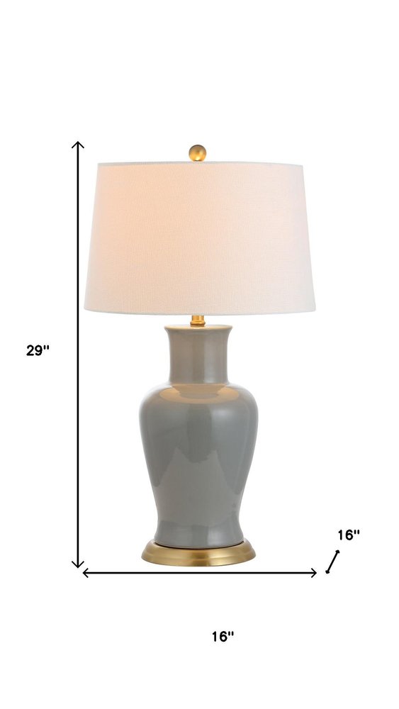 29" Gray And Gold Urn Bedside Lamp With Drum Shade. Lamp isolated on a plain white background, showing its gray color.