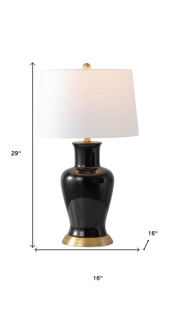 29" Gold Urn Table Lamp With Drum Shade. Table lamp isolated on a plain white background.