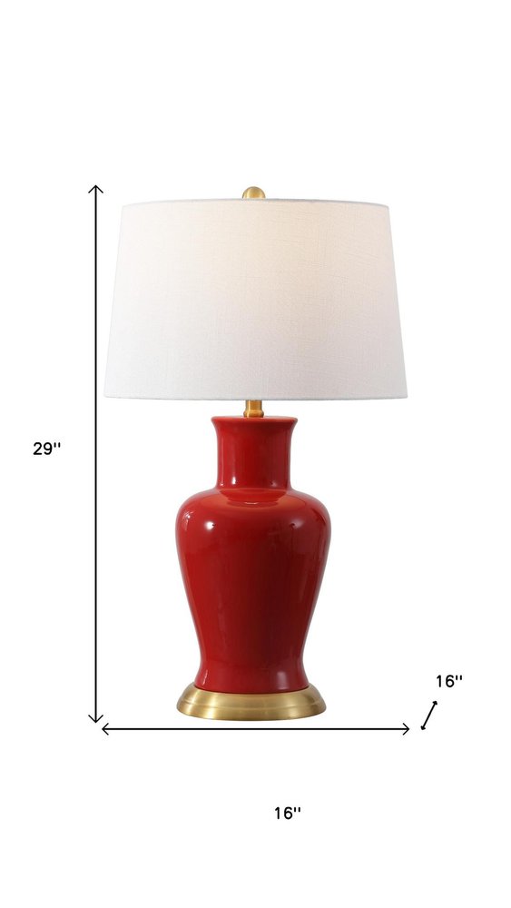29" Red And Gold Urn Table Lamp With Drum Shade. Table lamp isolated on a plain white background, in a red finish.