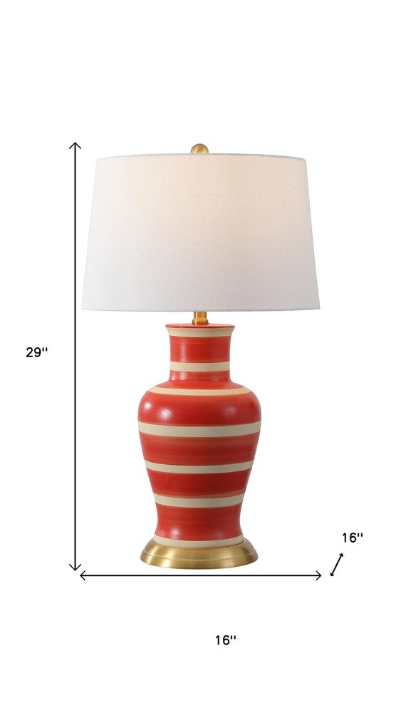 29" Gold Urn Table Lamp With Drum Shade. Table lamp isolated on a plain white background.