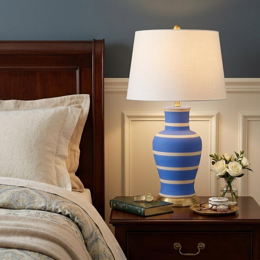 29" Blue Gold And Beige Urn Bedside Lamp With Empire Shade shown outdoors on an outdoor setting.