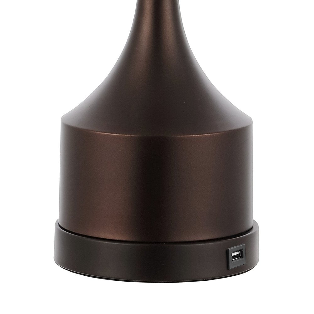 Close-up of the base of an antiqued bronze table lamp, showing a USB port on the bottom.