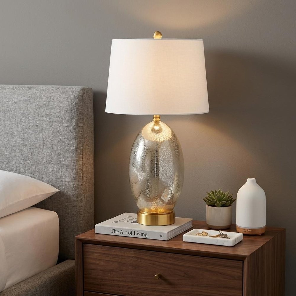 27" Gold Novelty Table Lamp With Empire Shade displayed on a dark wood tabletop in a furnished interior against a gray wall.