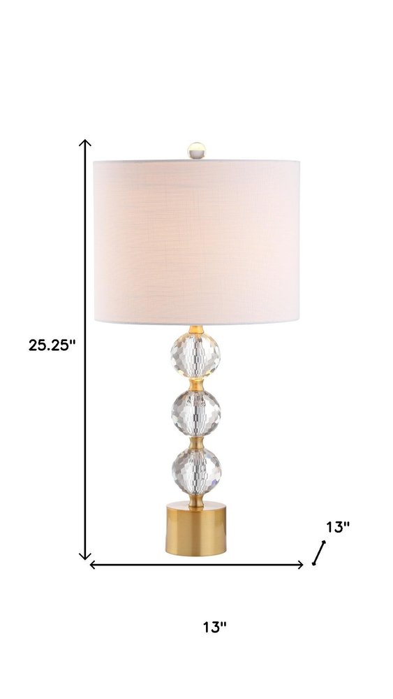 25" Gold Novelty Table Lamp With Drum Shade. Table lamp isolated on a plain white background.