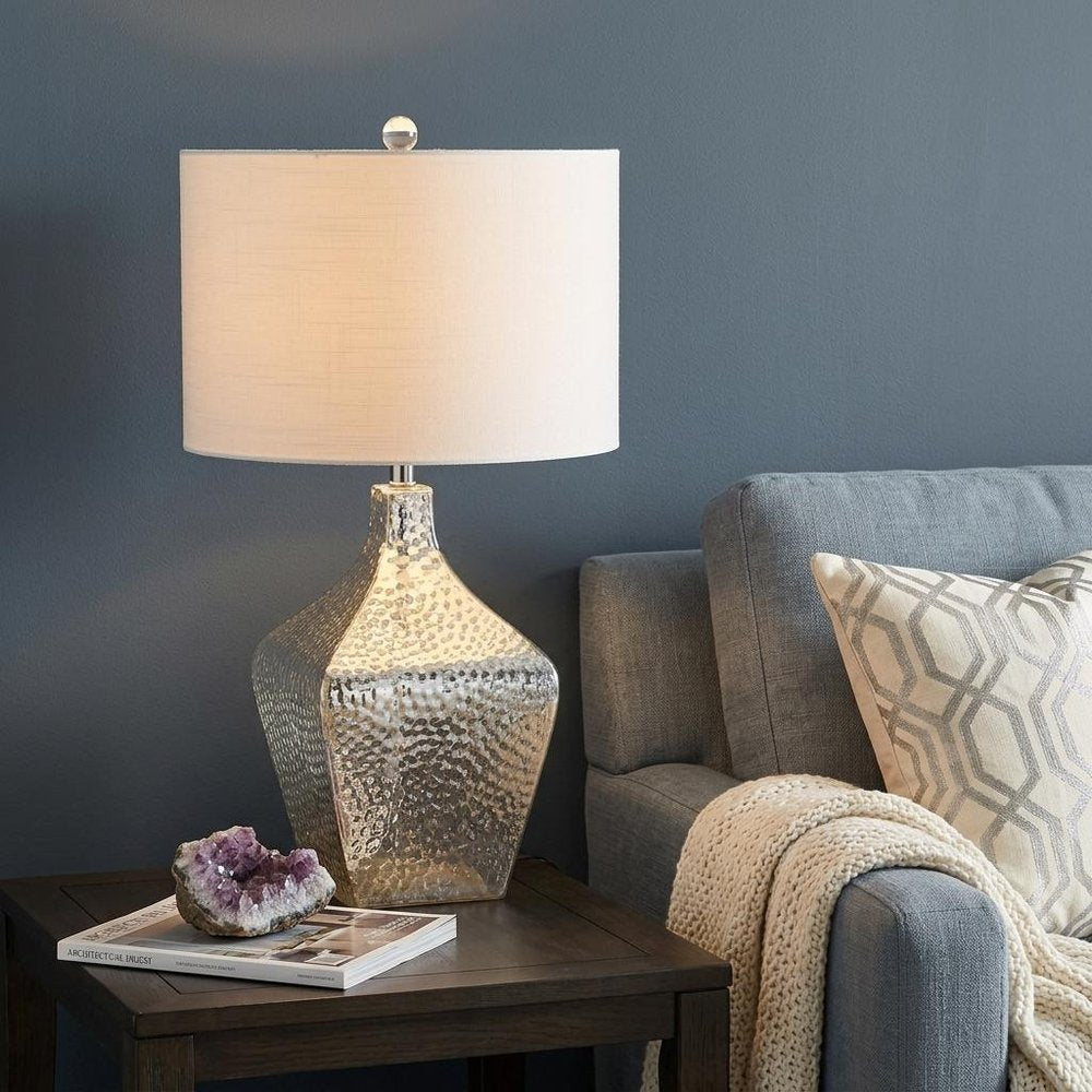 26" Clear Gourd Table Lamp With Drum Shade shown outdoors on an outdoor setting.