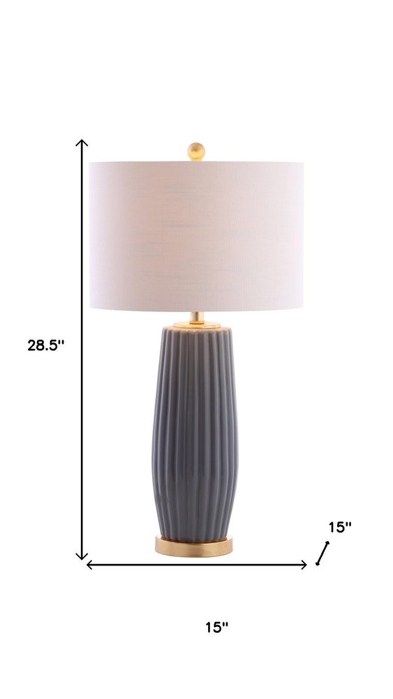 29" Dark Gray And Gold Table Lamp With Drum Shade. Table lamp isolated on a plain white background, finished in charcoal.