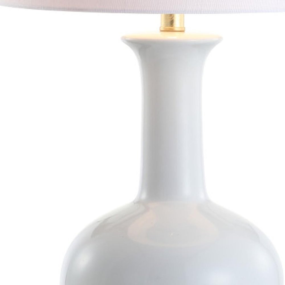 27" White And Gold Novelty Table Lamp With Drum Shade. Table lamp isolated on a plain white background, in a white finish.
