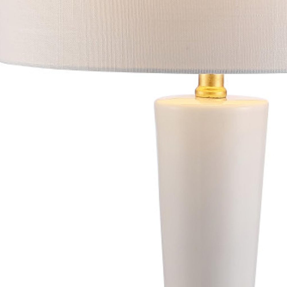 27" White And Gold Geometric Table Lamp With Drum Shade. Table lamp isolated on a plain white background, finished in white.