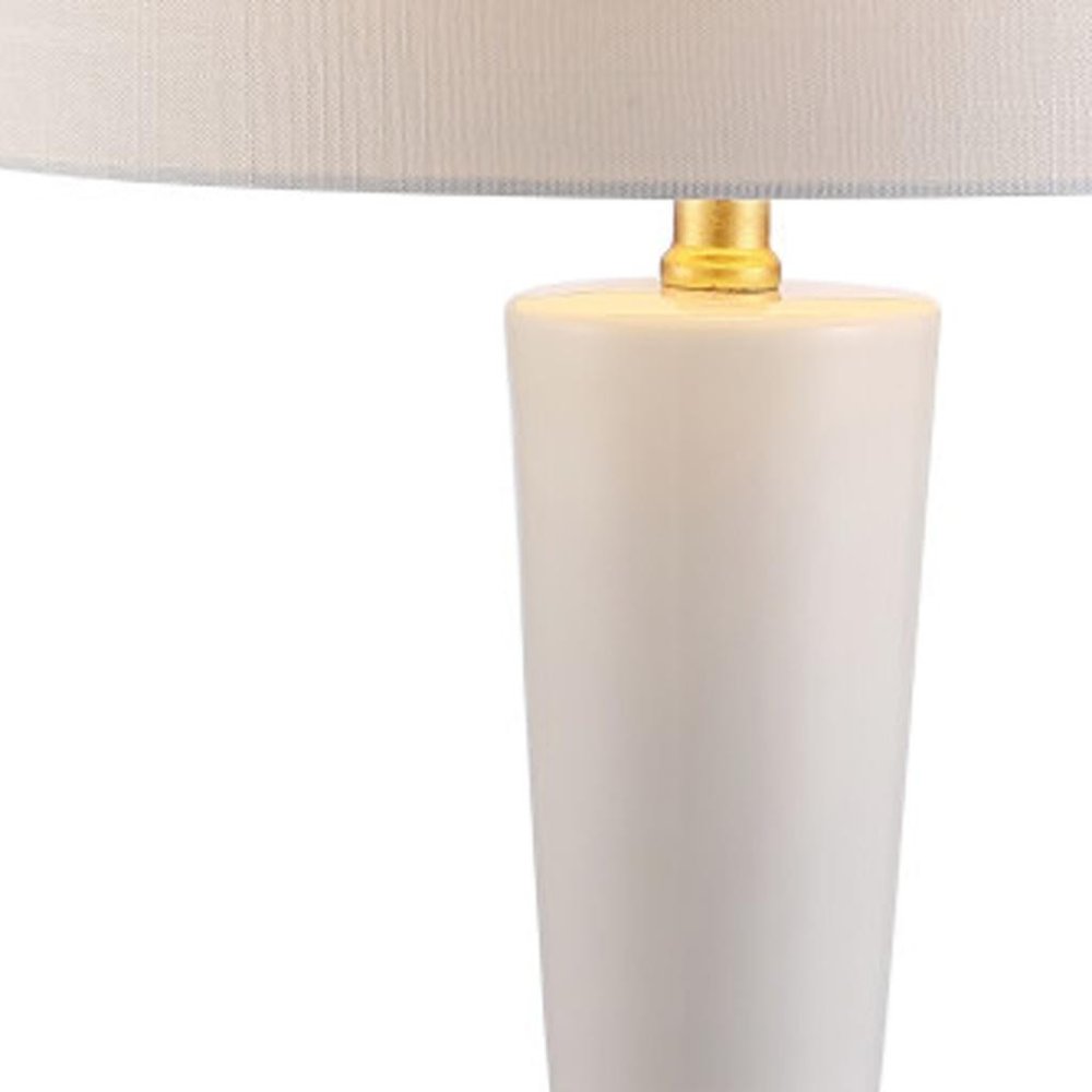 27" White And Gold Geometric Table Lamp With Drum Shade. Table lamp isolated on a plain white background, in a white finish.