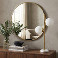 28" White Table Lamp With Globe Shade displayed on a dark wood tabletop in a furnished interior against a tan wall.