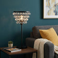 25" Bronze Lantern Table Lamp With Drum shown outdoors on an outdoor setting.