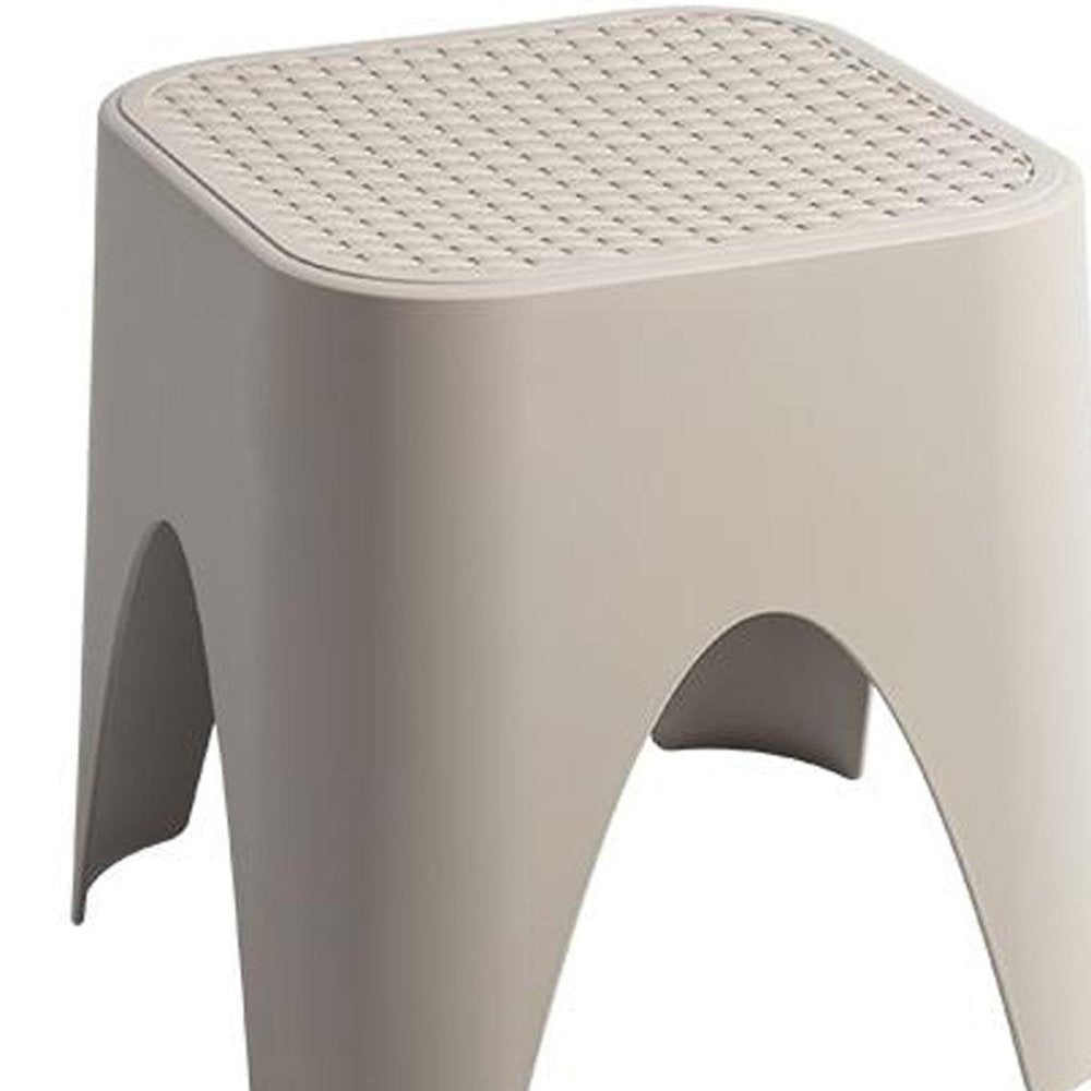 15" Plastic Outdoor Footstool Ottoman. Outdoor ottoman isolated on a plain white background, showing a plastic surface.