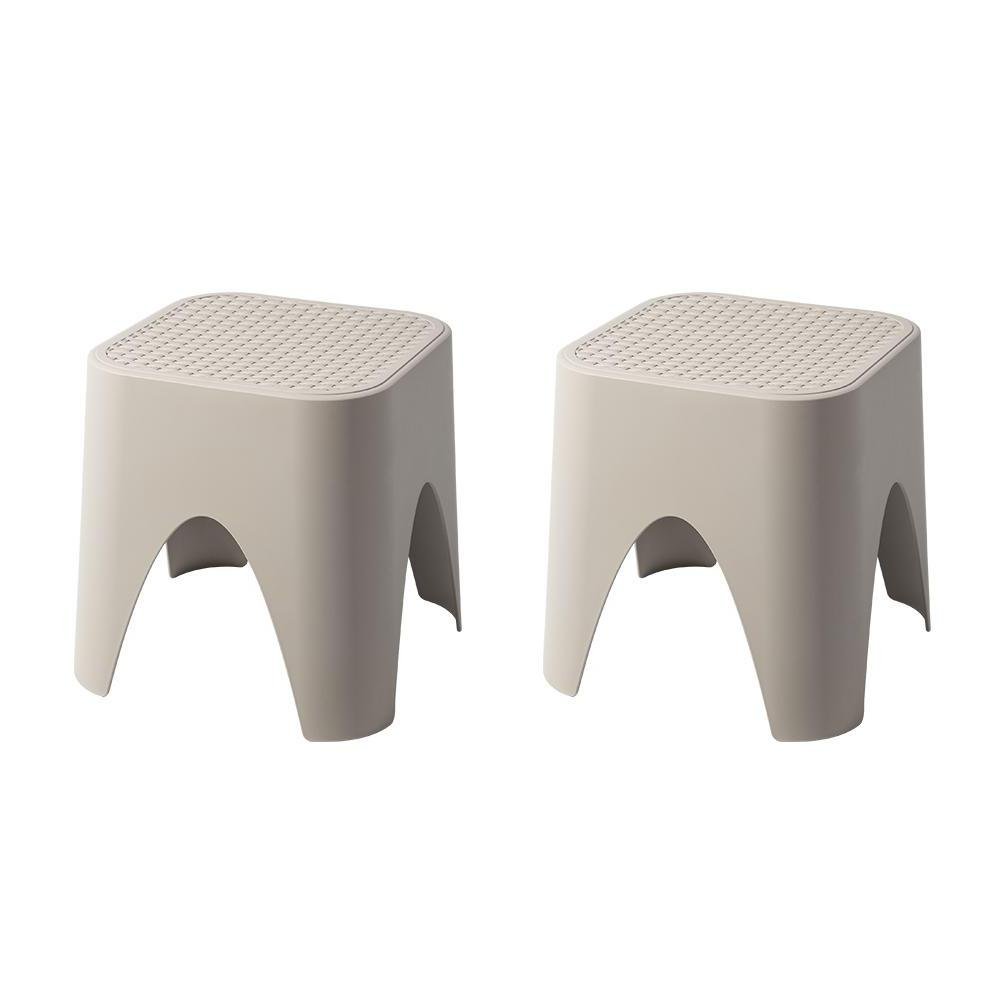 15" Plastic Outdoor Footstool Ottoman. Outdoor ottoman isolated on a plain white background, showing a plastic surface.