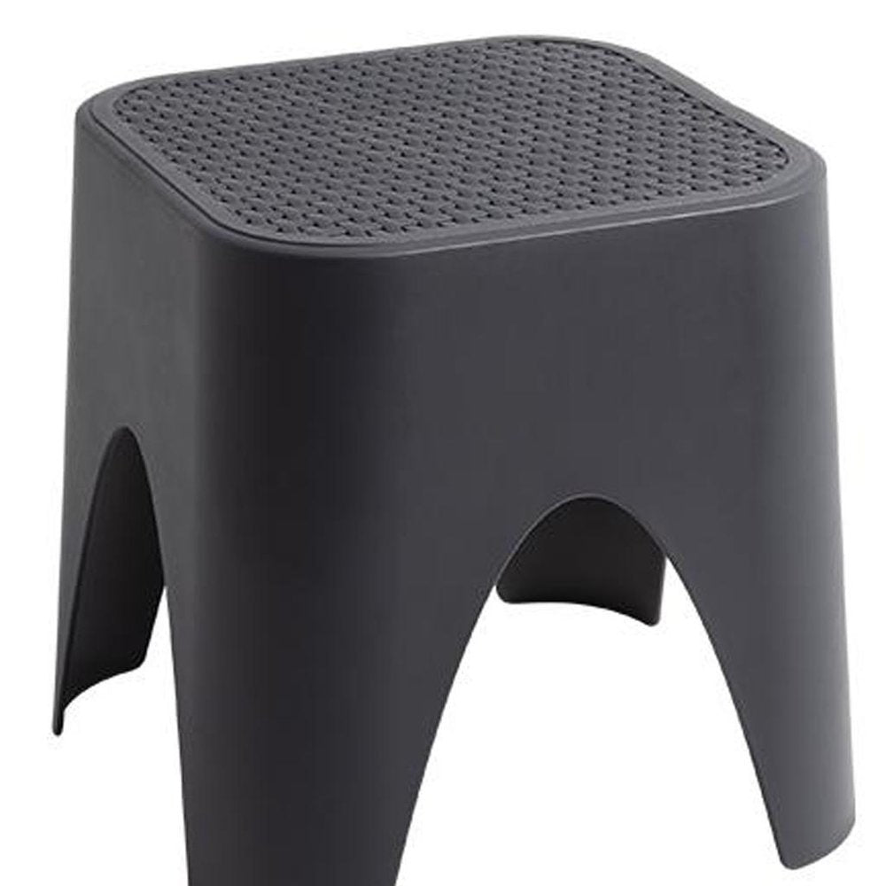 15" Plastic Outdoor Footstool Ottoman. Outdoor ottoman isolated on a plain white background, showing a plastic surface.