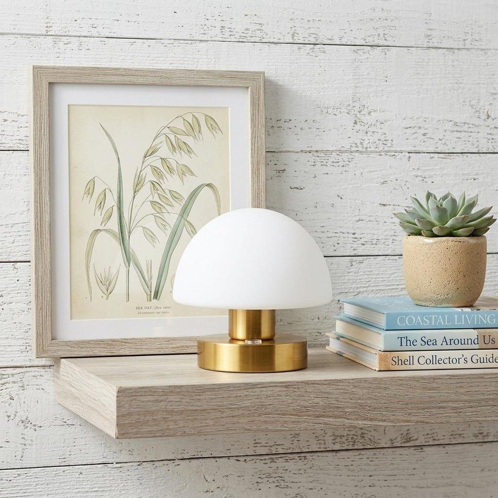6" Gold Novelty USB Table Lamp With Dome Shade displayed on a wood tabletop in a furnished interior against an off-white wall.