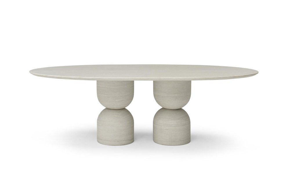 Oval beige marble dining table with a double pedestal base on a white background.