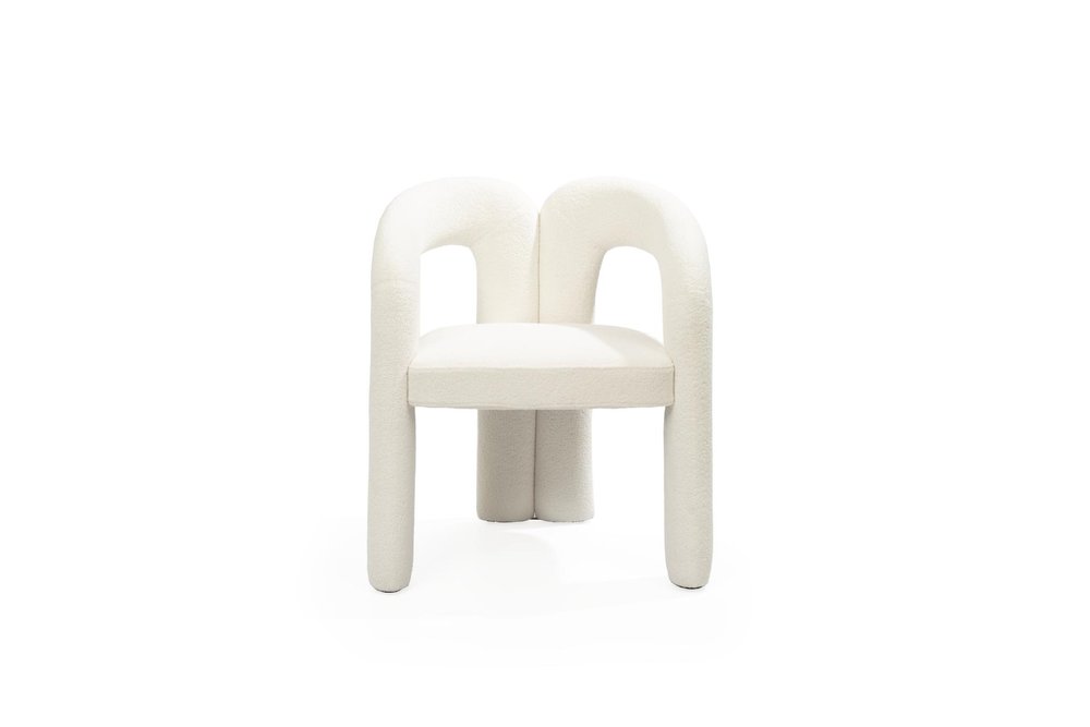 White boucle dining chair with a partially open back and curved arms, set against a white background.