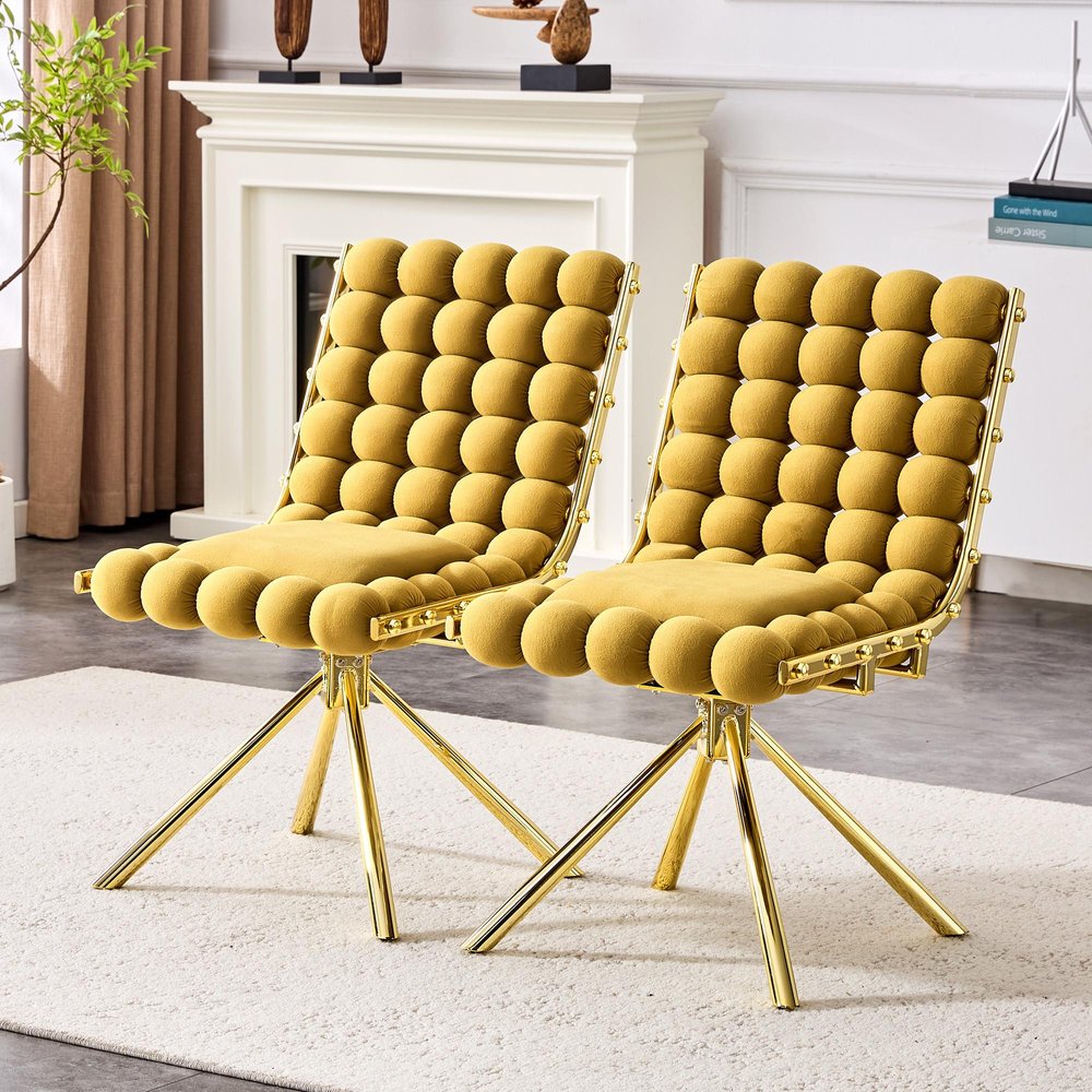 Set of Two Gold Tufted Microfiber Swivel Dining Side Chairs in a home interior