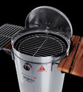 Silver stainless steel portable smoker barrel with open lid, grill grate, and wooden side shelves against a black background.