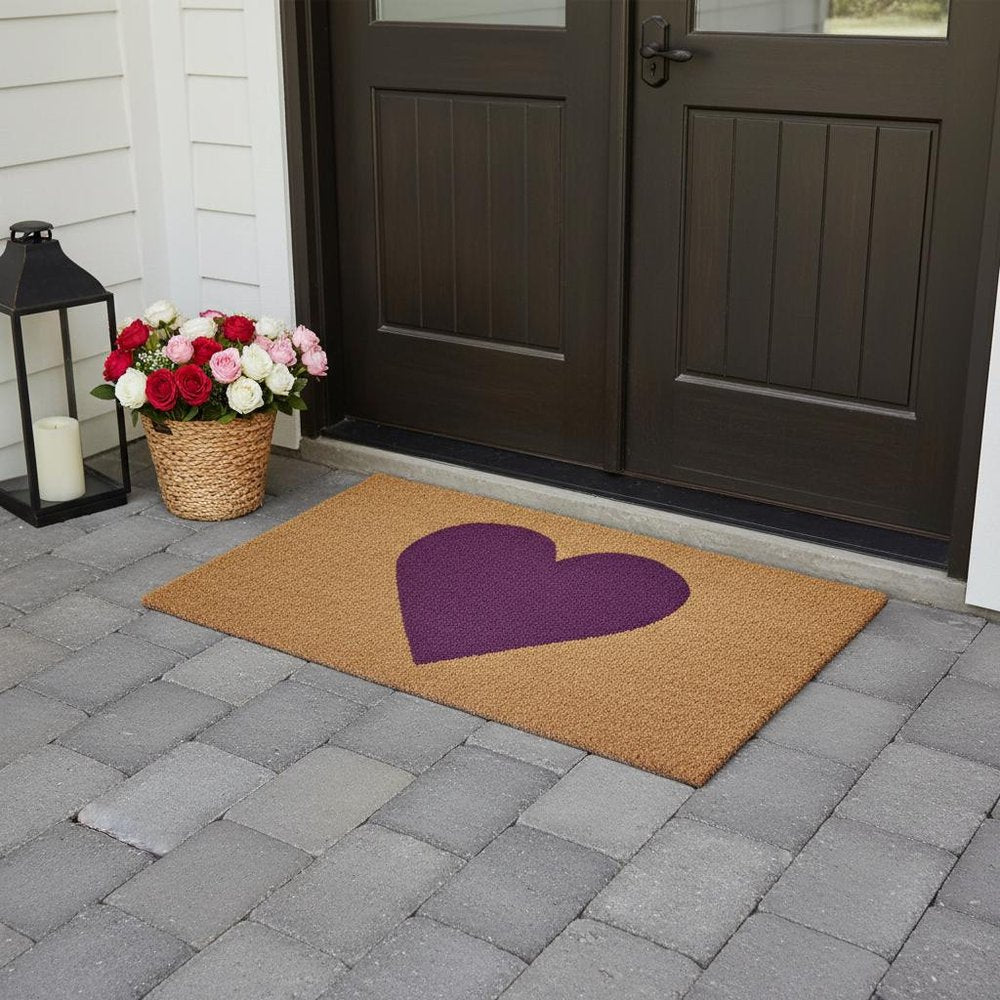 36" X 72" Brown And Purple Heart Outdoor Coir Door Mat styled in a furnished interior with a dark wall on a tiled floor.