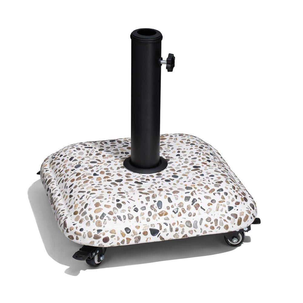 Square patio umbrella base with a terrazzo-like stone finish and black pole, featuring four wheels on a white background.